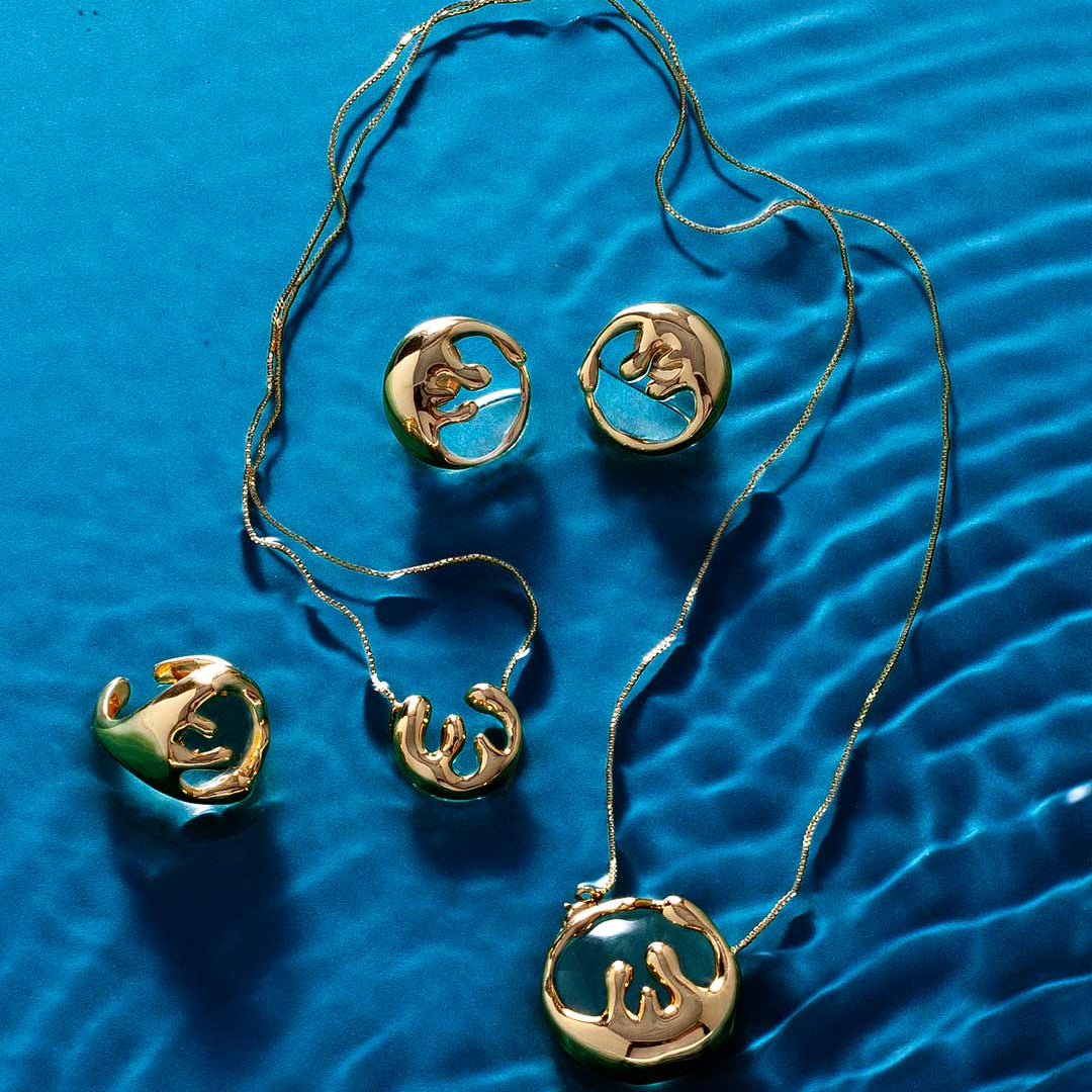 Modern organic gold jewelry collection with fluid sculptural design